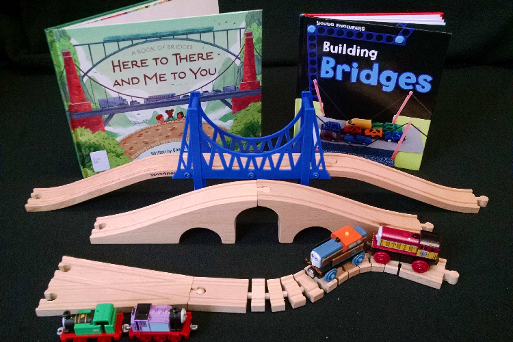 Photo of toy bridges, toy trains, and books about bridges